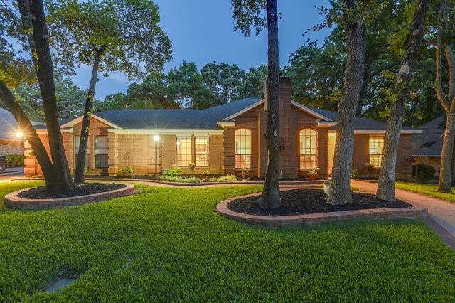 3008 Stone Bluff Ct, Arlington, TX 76017 - view of front of home with a front lawn and a chimney