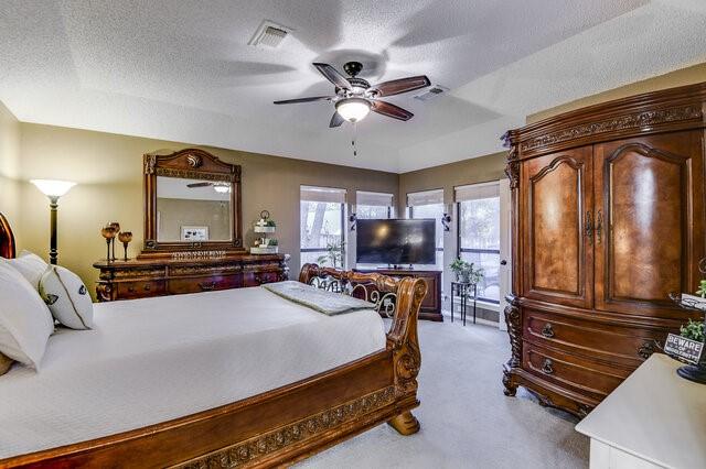 3008 Stone Bluff Ct, Arlington, TX 76017 - bedroom featuring carpet floors, access to exterior, a textured ceiling, and a ceiling fan