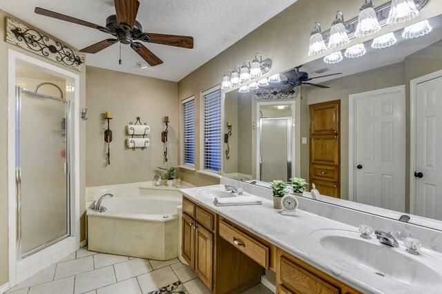 3008 Stone Bluff Ct, Arlington, TX 76017 - full bath with ceiling fan, a stall shower, a bath, tile patterned flooring, and double vanity