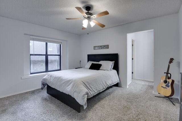 3008 Stone Bluff Ct, Arlington, TX 76017 - carpeted bedroom with a textured ceiling and ceiling fan
