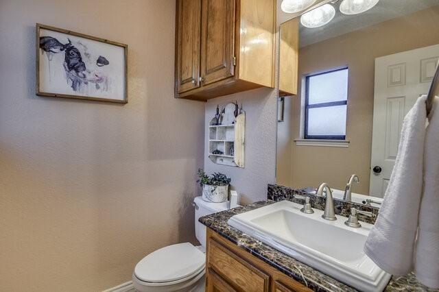 3008 Stone Bluff Ct, Arlington, TX 76017 - half bathroom featuring vanity and toilet