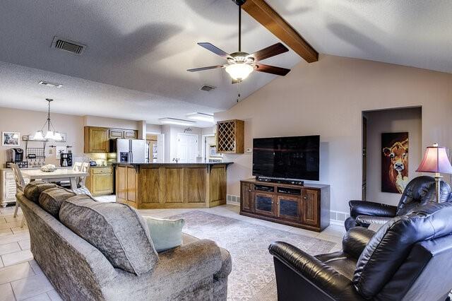 3008 Stone Bluff Ct, Arlington, TX 76017 - living room with a ceiling fan, a chandelier, and light tile patterned floors