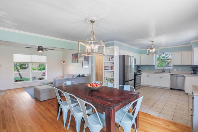 1714 O Pl, Plano, TX 75074 - dining space featuring a chandelier, crown molding, light wood finished floors, and a ceiling fan