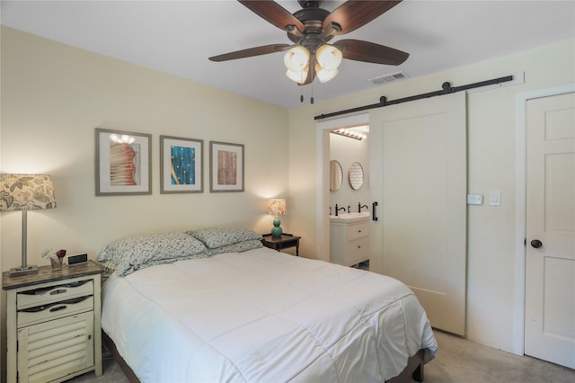 1714 O Pl, Plano, TX 75074 - carpeted bedroom with a barn door, a ceiling fan, and ensuite bath