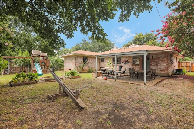 1714 O Pl, Plano, TX 75074 - rear view of property featuring a vegetable garden, brick siding, a patio area, a playground, and an outdoor living space