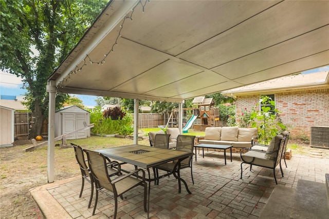 1714 O Pl, Plano, TX 75074 - fenced backyard with outdoor lounge area, a storage unit, a patio area, a playground, and outdoor dining space