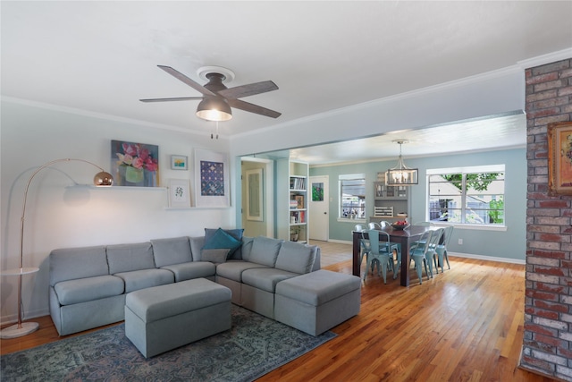 1714 O Pl, Plano, TX 75074 - living room featuring a chandelier, light wood-type flooring, ceiling fan, and crown molding