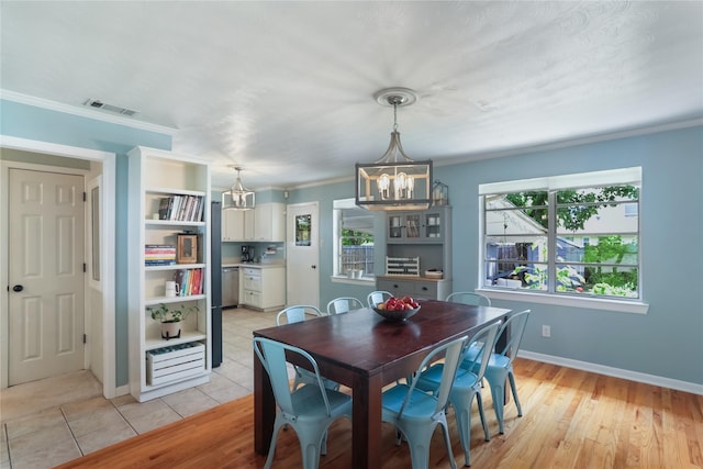1714 O Pl, Plano, TX 75074 - dining space featuring a chandelier, crown molding, and light wood finished floors