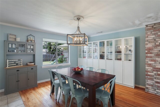 1714 O Pl, Plano, TX 75074 - dining room featuring a chandelier, light wood-type flooring, and crown molding