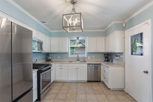 1714 O Pl, Plano, TX 75074 - kitchen featuring appliances with stainless steel finishes, white cabinets, a chandelier, light countertops, and ornamental molding
