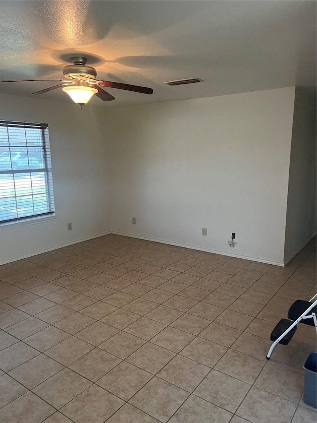 281 N Laramie Cir, Pilot Point, TX 76258 - unfurnished room featuring ceiling fan, light tile patterned floors, and a textured ceiling