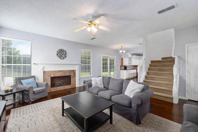 804 Wonder Way, Grapevine, TX 76051 - living area featuring wood finished floors, a textured ceiling, ceiling fan, a fireplace, and stairs