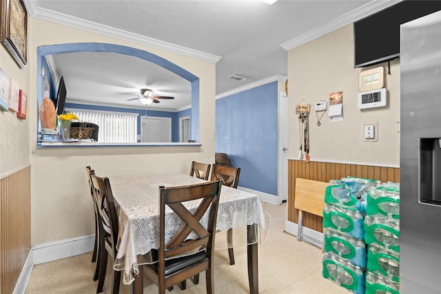 1106 Melrose St, Garland, TX 75040 - dining space featuring a ceiling fan, wood walls, wainscoting, and crown molding