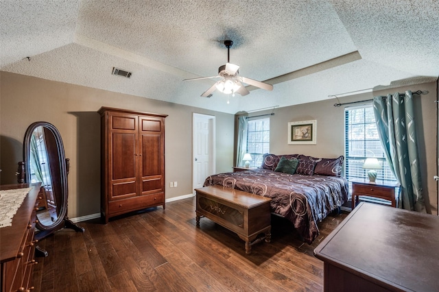 234 Raintree Dr, Highland Village, TX 75077 - bedroom with a textured ceiling, dark wood-type flooring, a ceiling fan, and vaulted ceiling