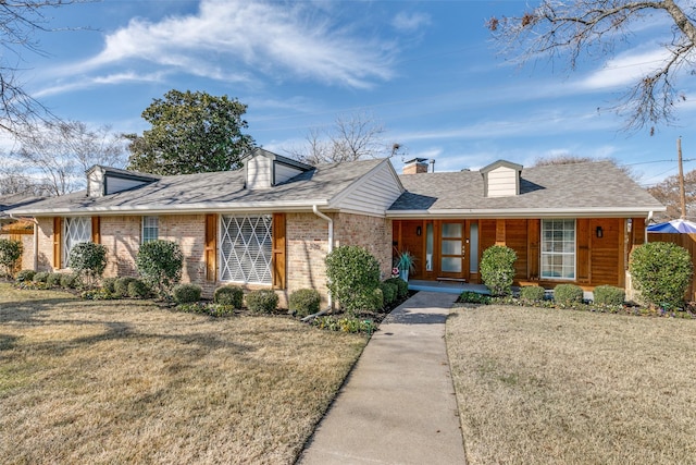 205 N Weatherred Dr, Richardson, TX 75080 - view of front of property featuring a front yard, brick siding, a shingled roof, and covered porch