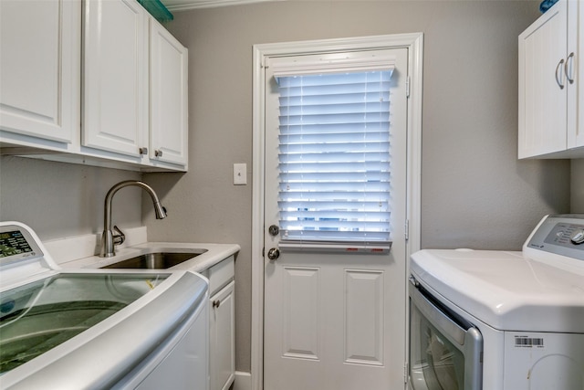 205 N Weatherred Dr, Richardson, TX 75080 - laundry room featuring washer and clothes dryer and cabinet space
