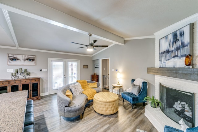 205 N Weatherred Dr, Richardson, TX 75080 - living room with wood finished floors, french doors, a brick fireplace, ceiling fan, and ornamental molding