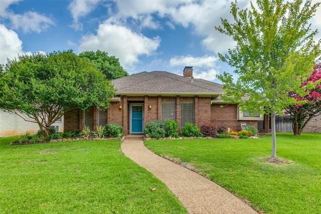 2307 Silver Holly Ln, Richardson, TX 75082 - view of front of house with a front yard, brick siding, a chimney, and a shingled roof