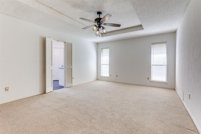 2307 Silver Holly Ln, Richardson, TX 75082 - empty room featuring a textured ceiling, light colored carpet, and ceiling fan