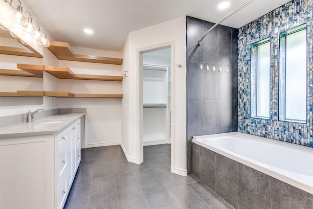 2307 Silver Holly Ln, Richardson, TX 75082 - bathroom featuring plenty of natural light, a garden tub, vanity, and a walk in closet