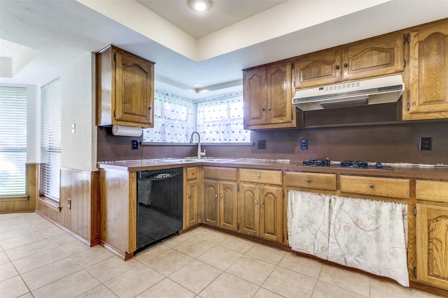 2307 Silver Holly Ln, Richardson, TX 75082 - kitchen featuring black dishwasher, under cabinet range hood, gas stovetop, light tile patterned floors, and a wainscoted wall