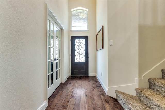 824 Mist Flower Dr, Little Elm, TX 75068 - foyer entrance with stairs, dark wood-style floors, a textured wall, and a high ceiling