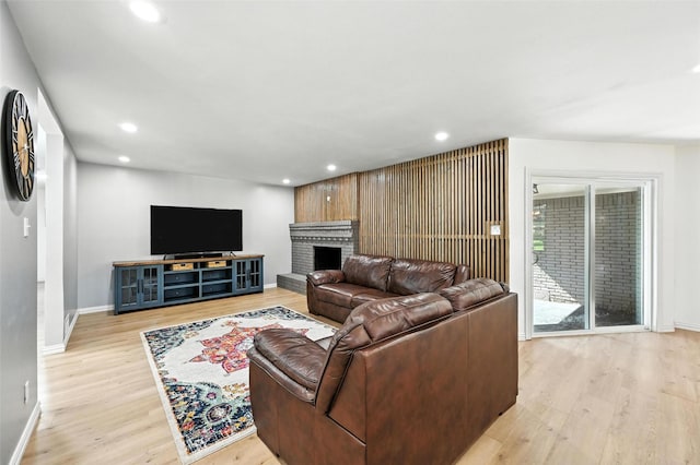 336 Davis Dr, Desoto, TX 75115 - living room featuring light wood-style floors, recessed lighting, and a brick fireplace