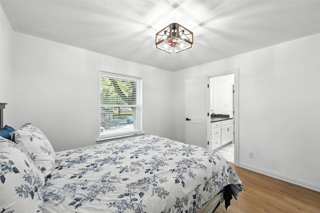336 Davis Dr, Desoto, TX 75115 - bedroom with light wood-style flooring and connected bathroom
