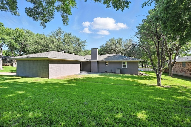 336 Davis Dr, Desoto, TX 75115 - rear view of house featuring a chimney, a yard, and brick siding