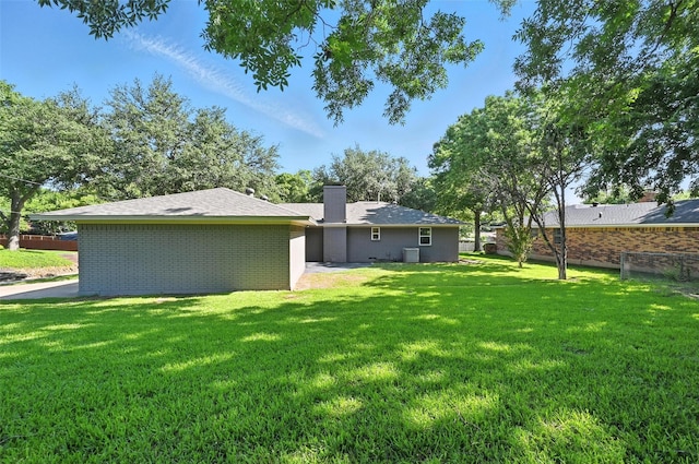 336 Davis Dr, Desoto, TX 75115 - back of property featuring a chimney, brick siding, and roof with shingles