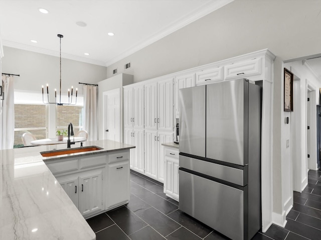 3813 Fall Wheat Dr, Plano, TX 75075 - kitchen with freestanding refrigerator, ornamental molding, white cabinetry, a chandelier, and light stone countertops