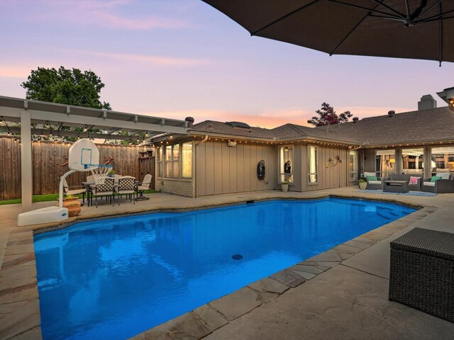 3813 Fall Wheat Dr, Plano, TX 75075 - pool at dusk with an outdoor hangout area, a patio, a storage unit, and a fenced backyard