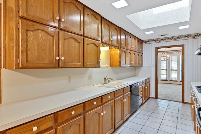 7254 Hialeah Cir W, North Richland Hills, TX 76182 - kitchen with a skylight, black dishwasher, and brown cabinetry