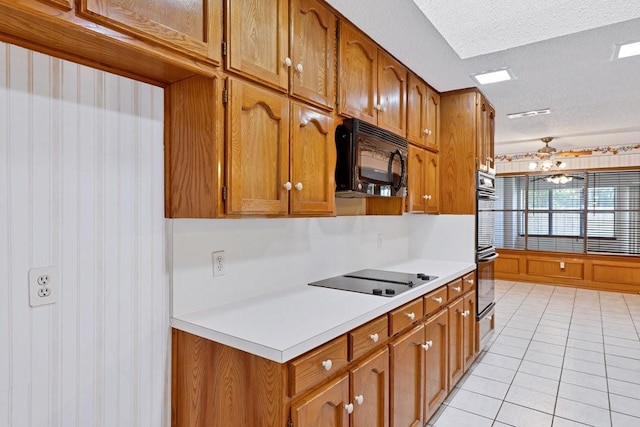 7254 Hialeah Cir W, North Richland Hills, TX 76182 - kitchen featuring black appliances, brown cabinetry, a textured ceiling, light countertops, and light tile patterned flooring