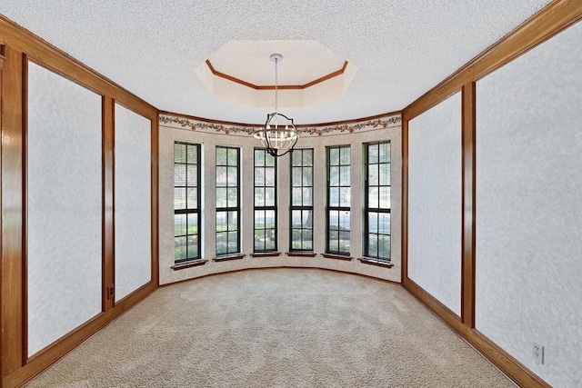 7254 Hialeah Cir W, North Richland Hills, TX 76182 - carpeted spare room with a chandelier, plenty of natural light, ornamental molding, a textured ceiling, and a tray ceiling