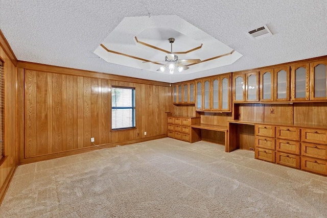 7254 Hialeah Cir W, North Richland Hills, TX 76182 - unfurnished office with a tray ceiling, built in desk, a textured ceiling, ceiling fan, and wooden walls