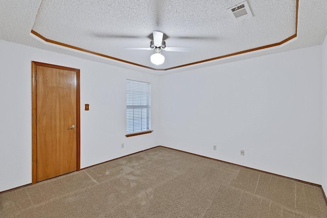 7254 Hialeah Cir W, North Richland Hills, TX 76182 - empty room with ceiling fan, a textured ceiling, carpet flooring, and a tray ceiling
