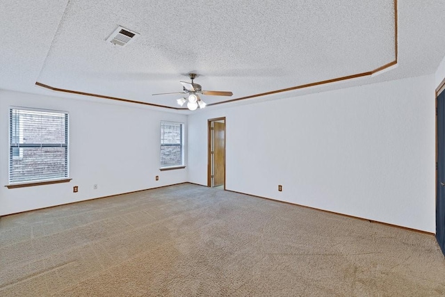 7254 Hialeah Cir W, North Richland Hills, TX 76182 - unfurnished room featuring a textured ceiling, carpet floors, a ceiling fan, and a tray ceiling