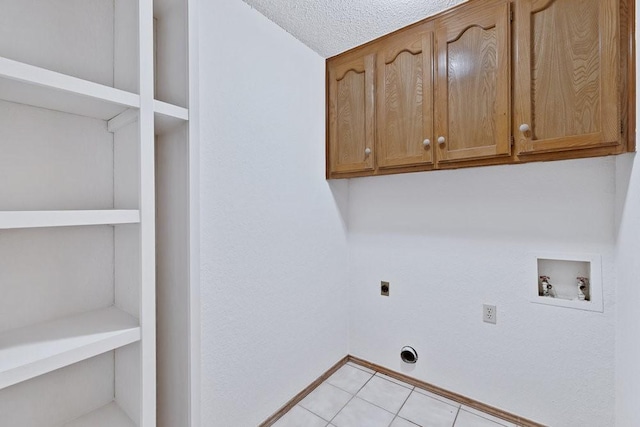 7254 Hialeah Cir W, North Richland Hills, TX 76182 - laundry area featuring hookup for an electric dryer, cabinet space, hookup for a washing machine, and light tile patterned floors