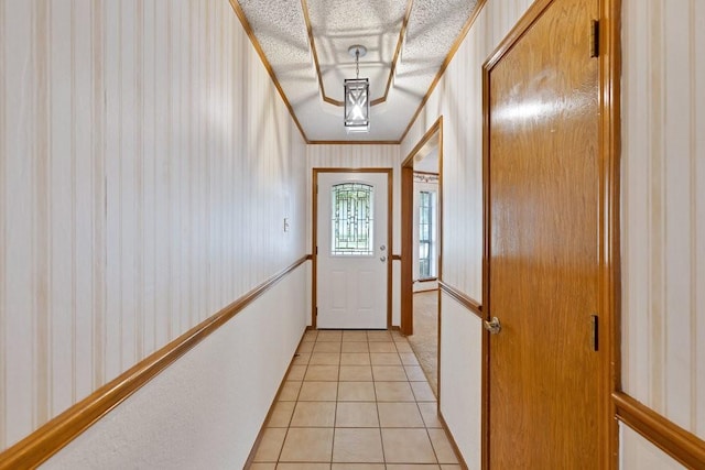 7254 Hialeah Cir W, North Richland Hills, TX 76182 - doorway with wallpapered walls, light tile patterned flooring, crown molding, and a textured ceiling