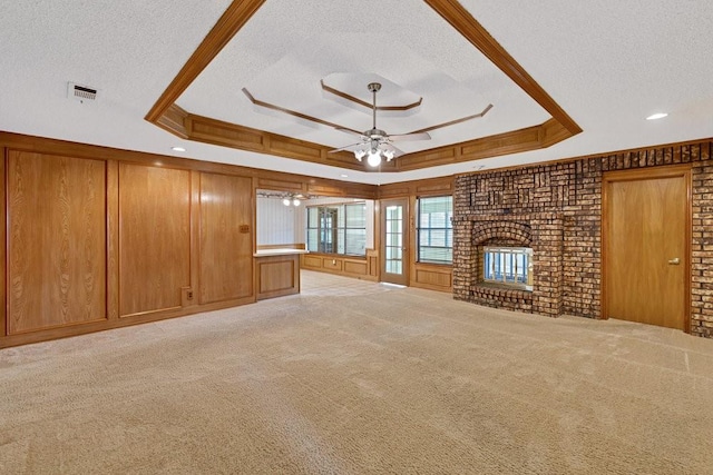 7254 Hialeah Cir W, North Richland Hills, TX 76182 - unfurnished living room with a tray ceiling, a textured ceiling, a ceiling fan, a fireplace, and light carpet