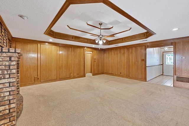 7254 Hialeah Cir W, North Richland Hills, TX 76182 - unfurnished room featuring a tray ceiling, light carpet, ceiling fan, and wooden walls