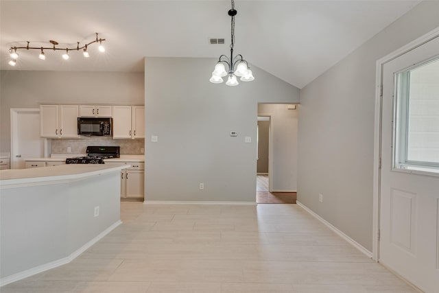 122 Ashbrook Trl, Forney, TX 75126 - kitchen featuring black microwave, decorative backsplash, light countertops, stove, and hanging light fixtures
