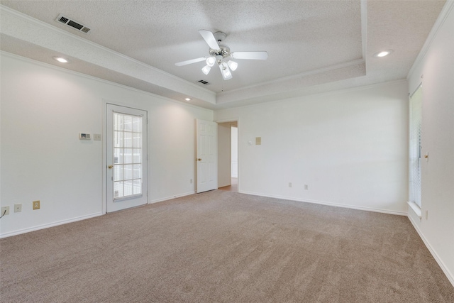 11275 Old Military Trl, Forney, TX 75126 - empty room with crown molding, light colored carpet, a tray ceiling, a textured ceiling, and a ceiling fan
