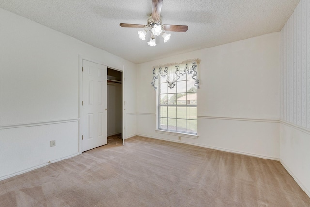 11275 Old Military Trl, Forney, TX 75126 - unfurnished bedroom featuring a textured ceiling, carpet, a closet, and a ceiling fan
