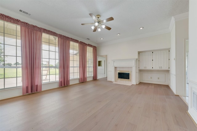 11275 Old Military Trl, Forney, TX 75126 - unfurnished living room featuring ornamental molding, ceiling fan, light wood-type flooring, and a fireplace with flush hearth