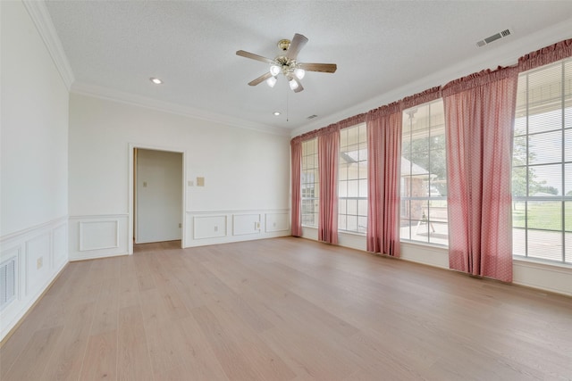 11275 Old Military Trl, Forney, TX 75126 - empty room with ornamental molding, a ceiling fan, light wood-style flooring, a decorative wall, and wainscoting
