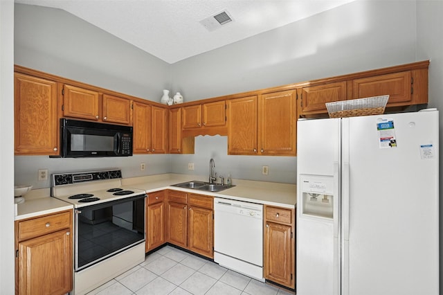 1450 Hampton Rd, Grapevine, TX 76051 - kitchen featuring white appliances, light tile patterned flooring, light countertops, vaulted ceiling, and brown cabinetry