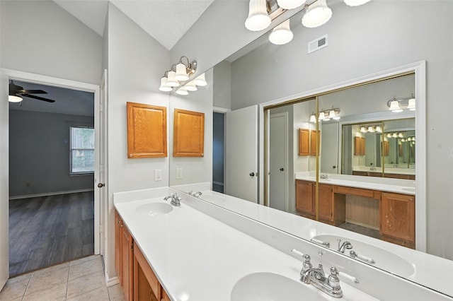 1450 Hampton Rd, Grapevine, TX 76051 - bathroom with lofted ceiling, double vanity, tile patterned flooring, and ceiling fan