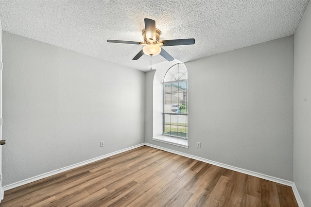 1450 Hampton Rd, Grapevine, TX 76051 - spare room featuring wood finished floors, a textured ceiling, and a ceiling fan